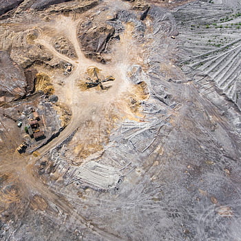 aerial photo, open field, mining site, aerial view, machinery, earth patterns, expansive view, mining machinery, earth textures, industrial landscape, aerial landscape