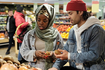 Muslim couple, buying groceries, fresh kiwis, vibrant supermarket, produce section, diverse couple, grocery shopping, supermarket produce, kiwi selection, couple shopping, fresh produce