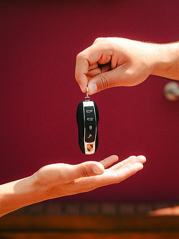 car key exchange, luxury car key, hands exchanging key, São Paulo Brazil, close-up hands, car key handover, luxury vehicle key, car key transfer, key exchange close-up, car key delivery, luxury car ownership