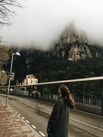 woman, black jacket, misty mountains, Monistrol de Montserrat, Spain, mountain view, outdoor scene, travel photography, scenic landscape, tourist destination, natural beauty