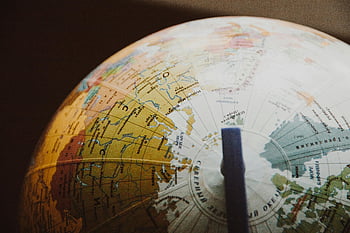 desk globe, shallow focus, globe details, world map, countries, regions, close-up image, globe photography, geographical features, desk accessory, shallow depth of field