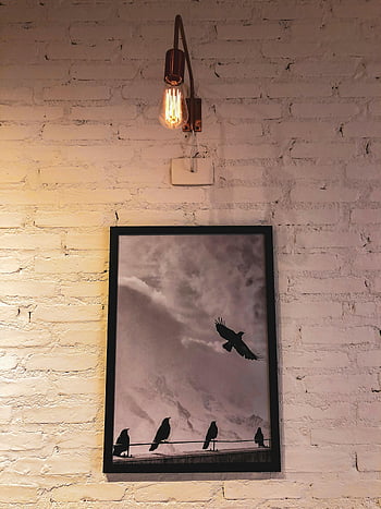 bird silhouettes, vintage art, Edison bulb, brick wall, framed painting, wall art, birds on wire, silhouette art, vintage lighting, interior decor, wall decoration