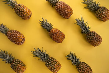 pineapples, yellow background, tropical themes, fresh pineapples, top view, vivid yellow, pineapple pattern, fruit photography, tropical fruit, pineapple design, pineapple art