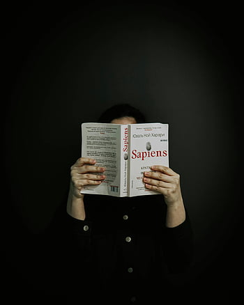 person reading, Sapiens book, dark studio, book cover, reading book, dark setting, Sapiens, studio setting, person reading book, dark background, book reading
