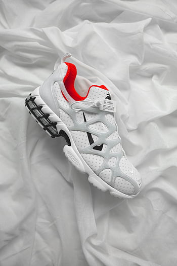 white athletic shoe, red accents, Nike sneaker, white textile, textured fabric, stylish sneakers, white background, athletic footwear, fashion shoes, sportswear, white and red shoe