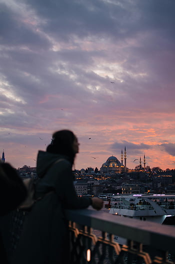 woman on bridge, Istanbul skyline, colorful sunset, city view, sundown, river, urban landscape, travel photography, evening scene, cityscape, silhouette