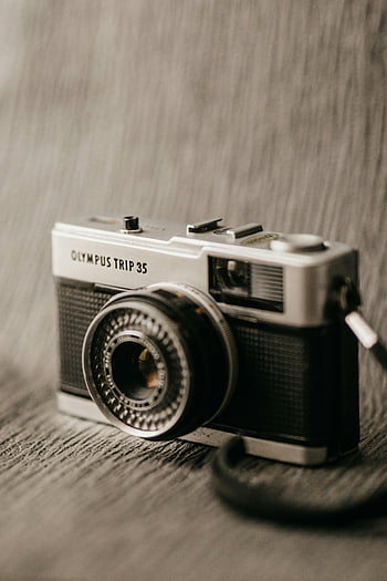 retro photo camera, Olympus Trip 35, classic camera, close-up, blurred background, vintage camera, photography equipment, film camera, camera lens, camera design, camera details