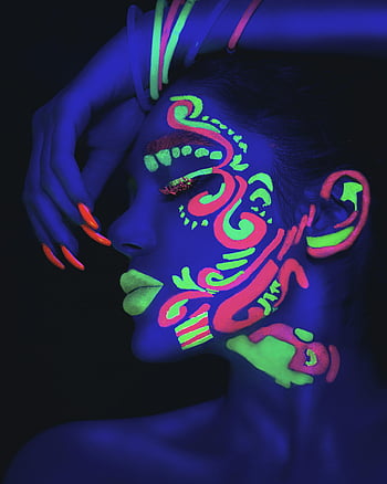 neon face paint, UV light, vibrant colors, portrait, woman, glowing, neon makeup, face art, fluorescent paint, artistic makeup, neon portrait