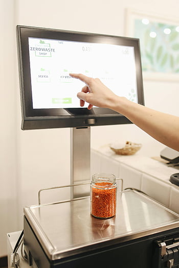 zero waste shop, touchscreen interface, bulk foods, weighing scale, customer interaction, flat screen display, sustainable shopping, eco-friendly store, bulk food weighing, digital interface, zero waste