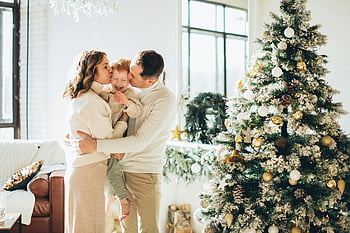 happy family, Christmas time, festive season, decorated Christmas tree, joyful family, family embrace, holiday season, Christmas decorations, family photo, Christmas joy, festive atmosphere