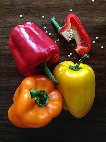 yellow bell pepper, red bell pepper, orange bell pepper, vibrant bell peppers, wooden surface, cooking inspiration, fresh vegetables, colorful peppers, healthy food, food photography, culinary ingredients