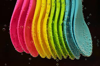 colorful spoons, plastic spoons, submerged spoons, water bubbles, vibrant colors, playful image, assorted-color spoons, multi-colored spoons, bright image, spoon lot, water submersion