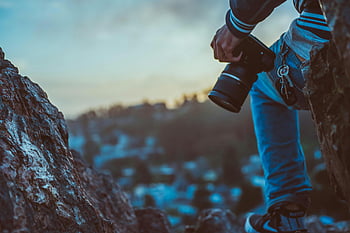 photographer, black DSLR camera, outdoors, rocks, sunset, scenic view, capturing, nature photography, landscape photography, outdoor photography, scenic landscape