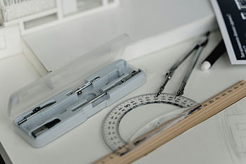 architectural drafting tools, compasses, ruler, workspace table, drafting, design tools, precision instruments, technical drawing, architectural design, drawing tools, protractor
