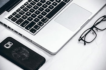 Macbook, eyeglasses, smartphone, modern workspace, laptop, desk, close-up, technology, office, productivity, gadgets
