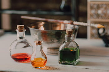 potions, close-up shot, colorful potions, wizard's wand, fantasy theme, mystical setup, glass bottles, cork stoppers, alchemy, magical elixirs, potion bottles