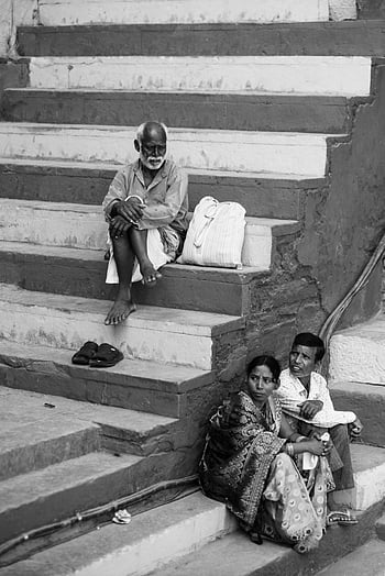 Indian people, sitting on stairs, black and white, urban life, city steps, three people, Indian urban, black and white photography, street scene, candid moment, cultural scene