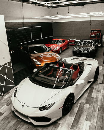 sports cars, luxury cars, modern garage, urban showroom, high-end vehicles, car collection, showroom setting, parked cars, sports car collection, modern urban, luxury sports cars