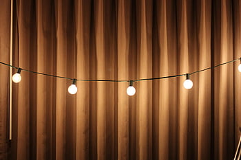 black string lights, brown curtain, cozy warm, ambient lighting, soft lighting, draped curtain, string lights, warm lighting, indoor lighting, decorative lighting, home decor