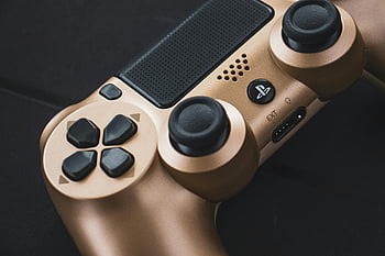 gold Playstation controller, close-up shot, game controller, buttons design, gaming accessory, close-up image, controller details, gaming hardware, gold controller, Playstation gaming, controller features