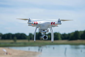 DJI quadcopter, selective-focus photography, aerial shot, white drone, camera, scenic landscape, sunny day, drone photography, quadcopter camera, outdoor drone, flying drone