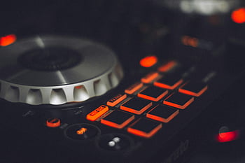 DJ controller, low light photography, illuminated buttons, control knobs, music technology, close-up, black DJ controller, music equipment, DJ equipment, electronic music, DJ mixer