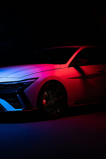 Hyundai Elantra N, left side view, vibrant neon lighting, studio setting, car photography, automotive design, studio lights, car studio, neon car, car showcase, Hyundai performance