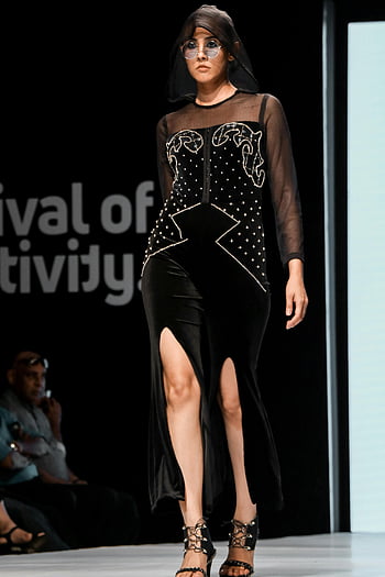 runway model, black outfit, fashion model, stylish black dress, runway event, high heels, festival of creativity, catwalk fashion, fashion show, model on runway, black dress with slit