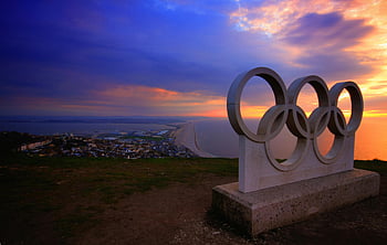 Olympic rings, coastal sunset, seaside town, concrete sculpture, Olympic sculpture, sunset view, coastal town, Olympic rings sculpture, seaside sunset, Olympic rings concrete, coastal landscape