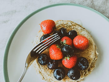 pancakes, strawberries, blueberries, white plate, fresh berries, breakfast, stack of pancakes, fruit topping, healthy meal, fork, dessert