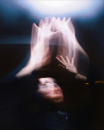 abstract blurred woman, hands in motion, blurred effects, mysterious impression, abstract art, artistic depiction, motion blur, abstract photography, blurred hands, dark background, light effects