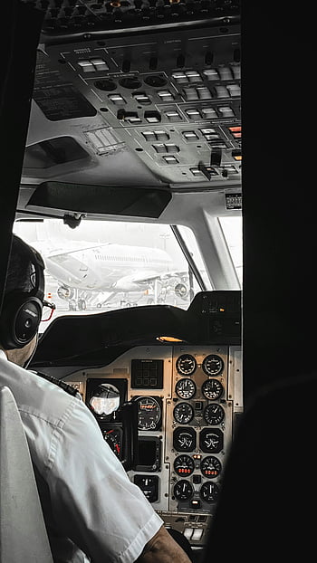 pilot, cockpit, cracked doors, flight controls, instruments, airplane, aviation, pilot uniform, dashboard, aircraft interior, view through doors
