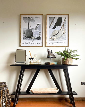 black console table, framed art, minimalist interior, white wall, stylish decor, black table, console table decor, minimalist design, interior design, home decor, framed prints