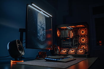 Futuristic Gaming PC, LED Lighting, high-tech gaming computer, glowing LED fans, dual monitor display, gaming setup, computer setup, LED fans, dual monitors, gaming computer, high-tech setup