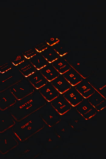 illuminated keyboard, backlit gaming keyboard, glowing red, dark setting, close-up photo, keyboard keys, red backlight, gaming accessory, computer keyboard, tech gadget, night mode