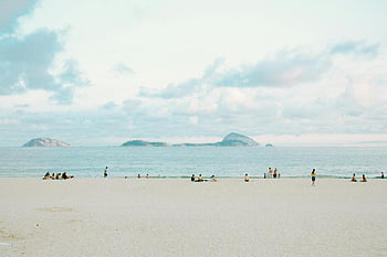 White Sand Beach, serene beach scene, people relaxing, Rio de Janeiro, Brazil, ocean view, sandy beach, coastal landscape, tropical beach, beachgoers, island view