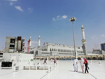 Muslim pilgrims, Masjid al-Haram, Mecca, ancient mosque, sunny day, clear blue sky, courtyard, pilgrimage, Islamic, religious site, Saudi Arabia