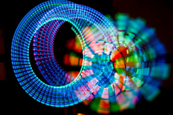 creative abstract design, colorful abstract display, vibrant light patterns, dynamic circular shapes, black backdrop, abstract art, light art, circular light patterns, abstract photography, colorful circles, abstract design