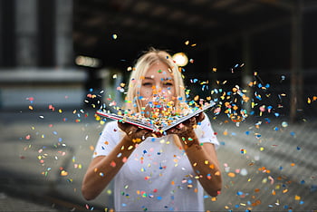 happy Holidays, woman, confetti, sparkles, blonde, fun, celebration, cheerful, joy, book, blow