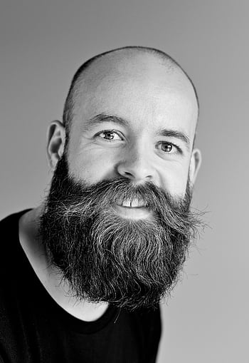 gray scale, bearded man, black and white, portrait, smiling, bald man, large beard, studio setting, facial hair, male portrait, monochrome photography