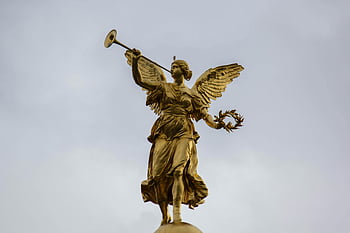 gold angel statue, golden angel, angel statue with trumpet, cloudy sky background, majestic statue, golden angel statue, golden trumpet, angel sculpture, cloud backdrop, angel wings, angel figure