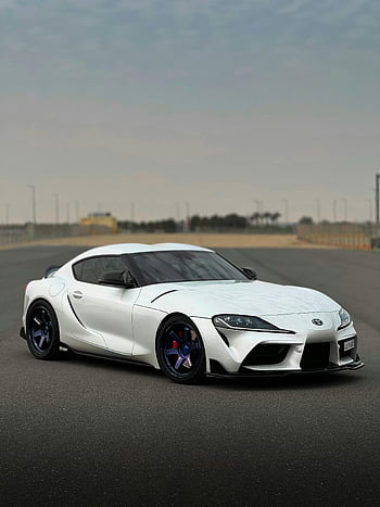 white sports car, Toyota Supra, sleek design, empty racetrack, stylish car, white Toyota, Supra car, sports car design, empty track, car photography, automotive design