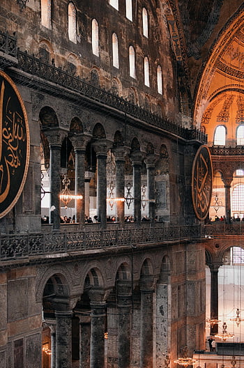 Hagia Sophia Mosque, grand interior, historic architecture, cultural heritage, majestic ancient mosque, stunning view, spacious interior, chandeliers, arches, columns, cultural landmark