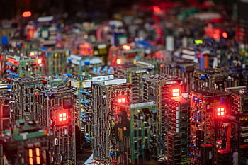 close-up semiconductors, illuminated circuit boards, electronic design, cityscape view, intricate electronics, technology photography, circuit board art, semiconductor technology, electronic components, tech cityscape, electronic cityscape