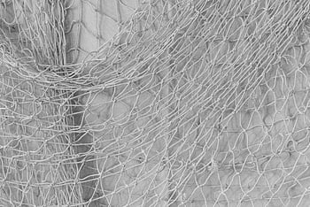 white fish net, close-up shot, intertwined fabric, fishnet texture, monochrome pattern, detailed close-up, fabric texture, net pattern, white netting, monochrome image, fishing net