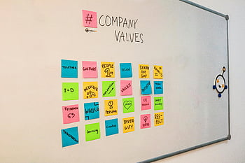 sticky notes, whiteboard, company values, teamwork, bright sticky notes, highlighting values, office culture, gender pay gap, inclusive culture, feedback, learning