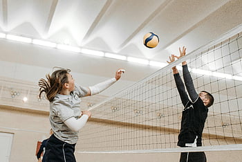 people playing volleyball, indoor volleyball, competitive spirit, volleyball match, athletes, thrilling match, energy, volleyball net, indoor sports, volleyball players, sports action
