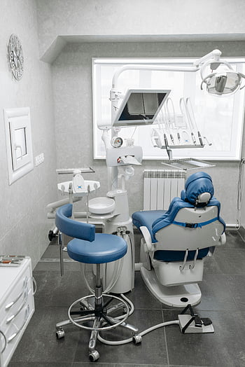 Blue and White Dental Chair, dental office, modern dental office, dental equipment, bright lighting, clean dental office, dental chair, dental room, dental interior, dental furniture, dental tools