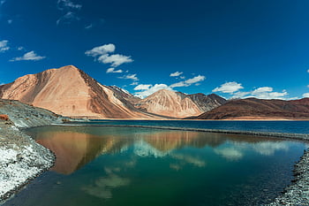 Pangong Lake, Himalayan mountains, clear blue sky, white clouds, beautiful panorama, majestic mountains, mountain lake, scenic landscape, natural beauty, travel destination, outdoor photography