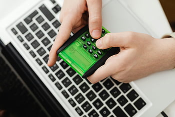 calculator, green calculator, hands using calculator, laptop keyboard, business tasks, finance tasks, person using calculator, green device, financial calculations, office work, technology tools